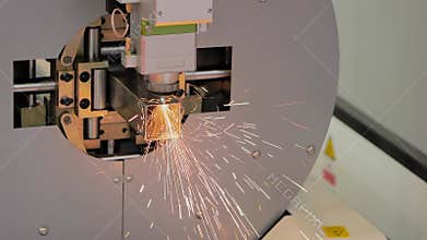 Laser cutting machine working with metal square pipe with sparks - slow motion