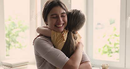 Affectionate foster mother hold in arms beloved adopted kid girl