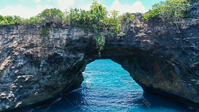 Aerial view on amazing Broken Beach Pasih Uug in Nusa Penida with natural arch, bridge and sea pool on background nature