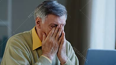 Senior mature older businessman looking laptop nervous work stress problems losing failure at home office elderly man