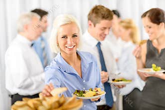 Smiling business woman during company lunch buffet