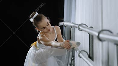 Teen caucasian ballerina girl teenager dancer child student in dance hall doing choreographic exercise at dance school