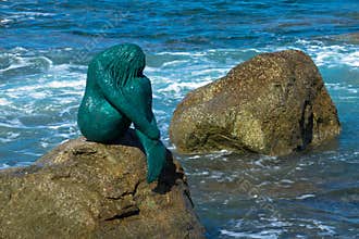 Mermaid statue on rock at L`ile Rousse harbor in the Balagne region of Corsica