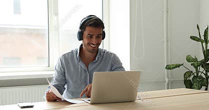Excited Latin salesman offer great deal to customer using laptop