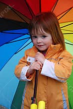 Toddler girl with  giant colorful umbrella