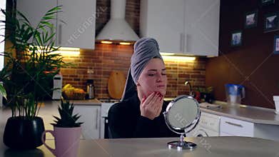 woman feeling shock while looking acne and scar occur on face