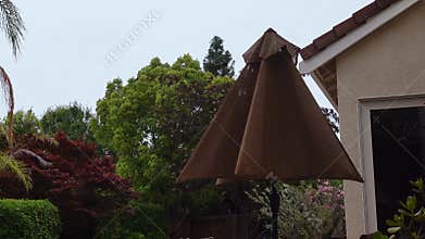 Windy day moving backyard umbrella