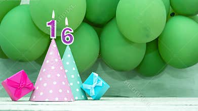 Birthday number 16, a beautiful card with balloons and numbers from candles, a happy birthday background for a girl.