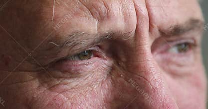 Close up cropped view older serious man staring into distance