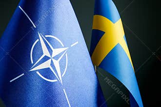 KYIV, UKRAINE - May 1, 2022. Close-up of the flags of Sweden and NATO.