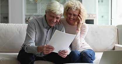 Mature couple read paper notification feel satisfied by good news