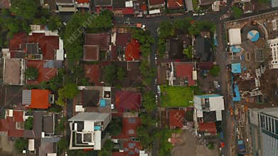 Aerial birds eye overhead top down view moving along the street in dense urban neighborhood in Jakarta, Indonesia
