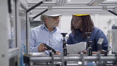 Older factory engineer training black employee