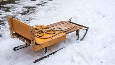 Winter sleds on snowy ground  metal sleds. Wooden sleds at a ski resort.