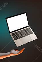 Levitating laptop with keyboard, blank copy space and male hand isolated on green background, for blog or advertising
