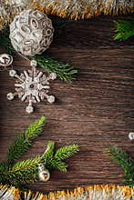 Christmas Tree Branches and Snowflakes on a Brown Background with Copy Space