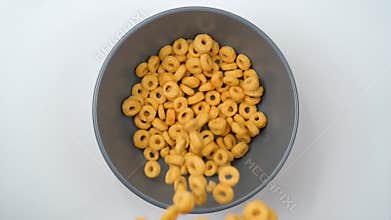 Grain cheerios cereal falling into the bowl