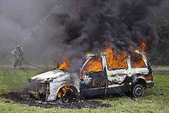 Firefighter tackling car fire