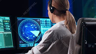 Workplace of the professional air traffic controller in the control tower. Female aircraft control officer works using