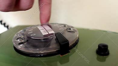 Hand dialing old antique rotary telephone