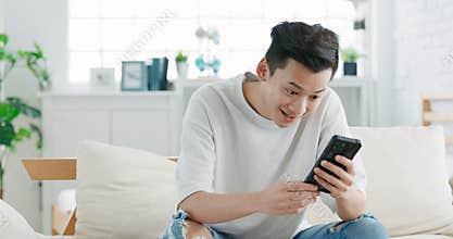 Happy young man  looking at cell phone celebrate receiving  good news