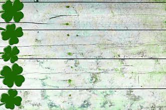 St Patricks day background. Shamrocks over a light green wood background