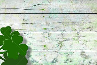 St Patricks day background. Shamrocks over a light green wood background