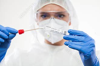 Healthcare professional holding Coronavirus COVID-19 test kit equipment