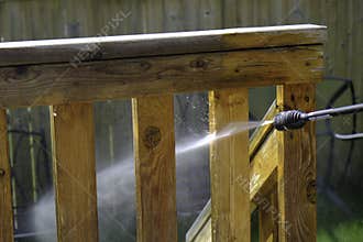 Cleaning House Deck in summer with pressure hose