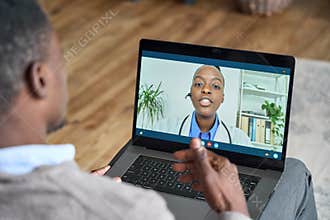 Online telehealth meeting of patient and doctor at home using laptop.