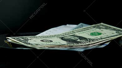 Close-up of a metal tray for money in a female hand, American dollars banknotes, Restaurant bill, calculator, tip money concept,
