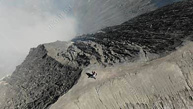 Couple embracing on ridge of Mount Bromo volcano