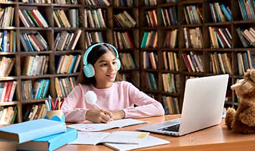 Happy smiling indian student having online virtual learning class on laptop.