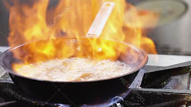 Chef cooking shrimps - flaming the food