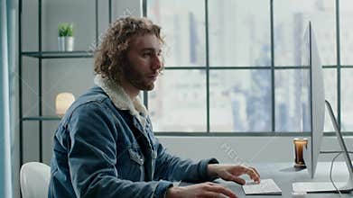 Freelancer in denim jacket with fur collar works on project