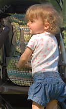 Profile of white toddler with long curly hair