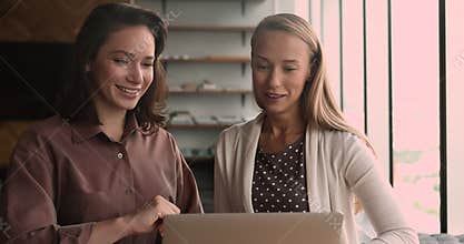 Mentor teach intern provide assistance with task using laptop