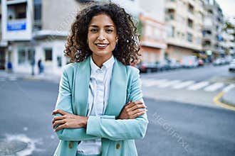 Young hispanic business woman wearing professional look smiling confident at the city