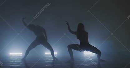 Silhouette of group dancers of contemporary ballet, ow key