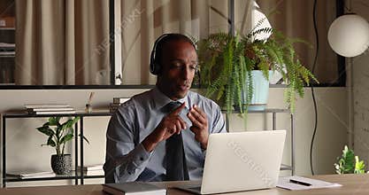 Serious 40s young african american businessman holding video call meeting.
