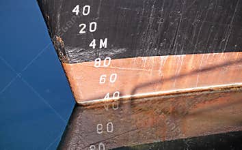 Draft measurement scale or depth gauge on the hull of a large ship