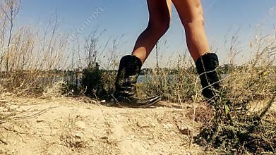 Female on the background of summer nature traditional American cowboy boots