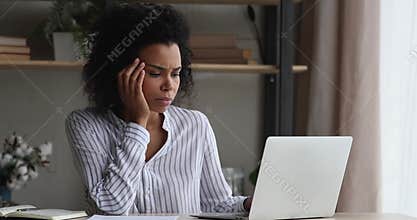 Thoughtful millennial african woman considering problem solution.