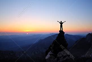 Silhouette of men on top of the mountain
