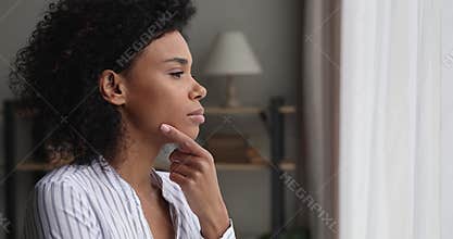 Thoughtful young african american woman considering problem solution.