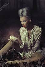 Sad woman holding candle