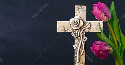 Ornate cross  wit purple tulip flowers on a dark background. Condolence card. Empty place for emotional sentimental quote or text