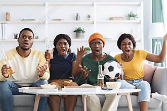 Furious african american friends watching football game on TV