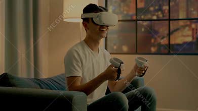 Interested Asian guy gamer in virtual reality headset