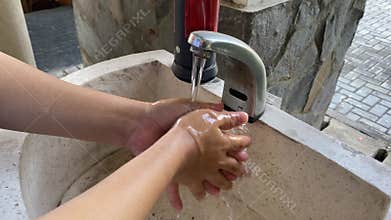 An automatic handwashing station complete with red soap